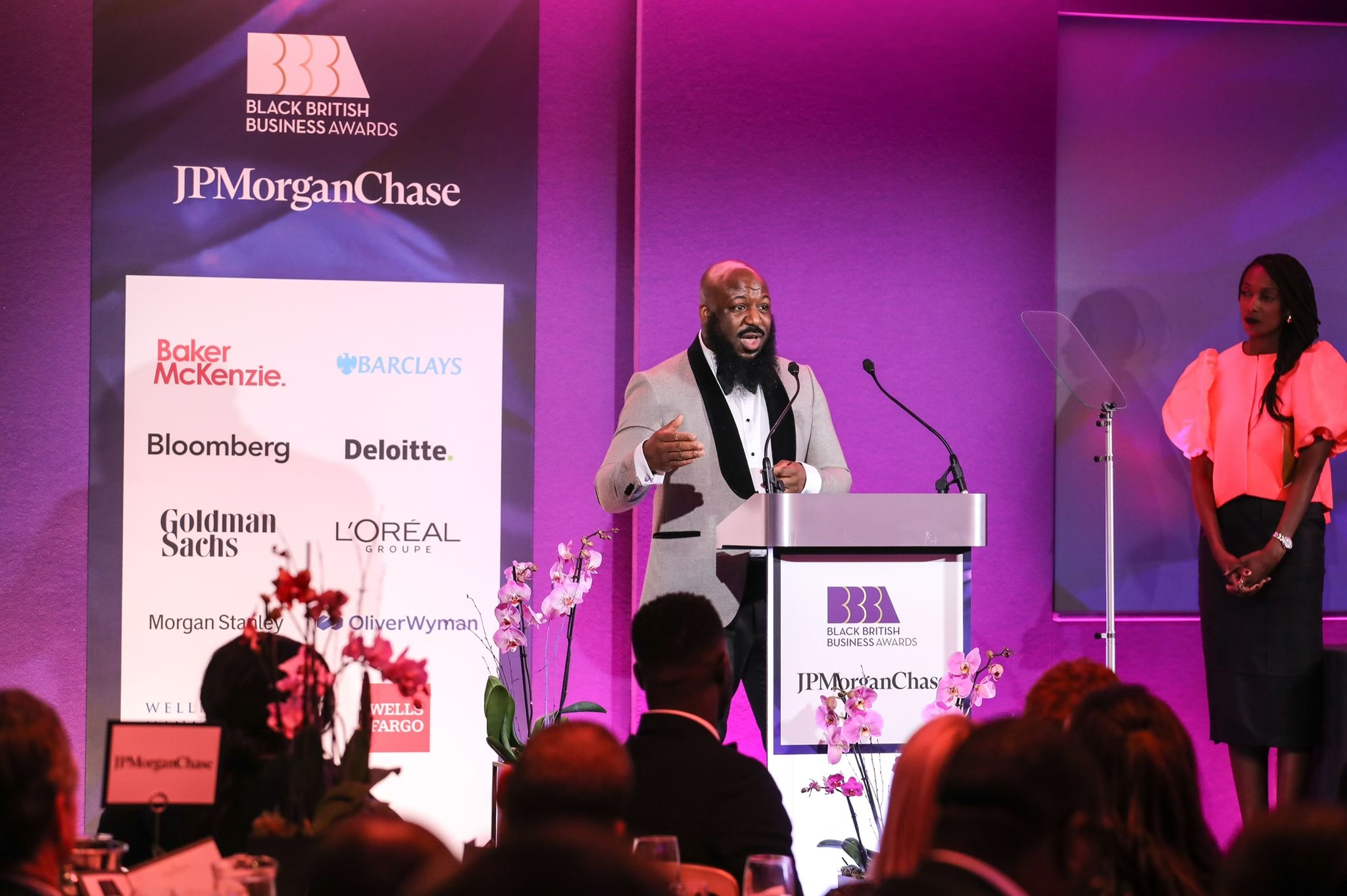 Leon delivering a keynote to a large audience